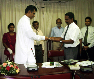 Handing over the NAP to Hon PC Ranawaka, M.P. (Left) Minister of Environment by Prof. B Marambe, Dean Faculty of Agriculture